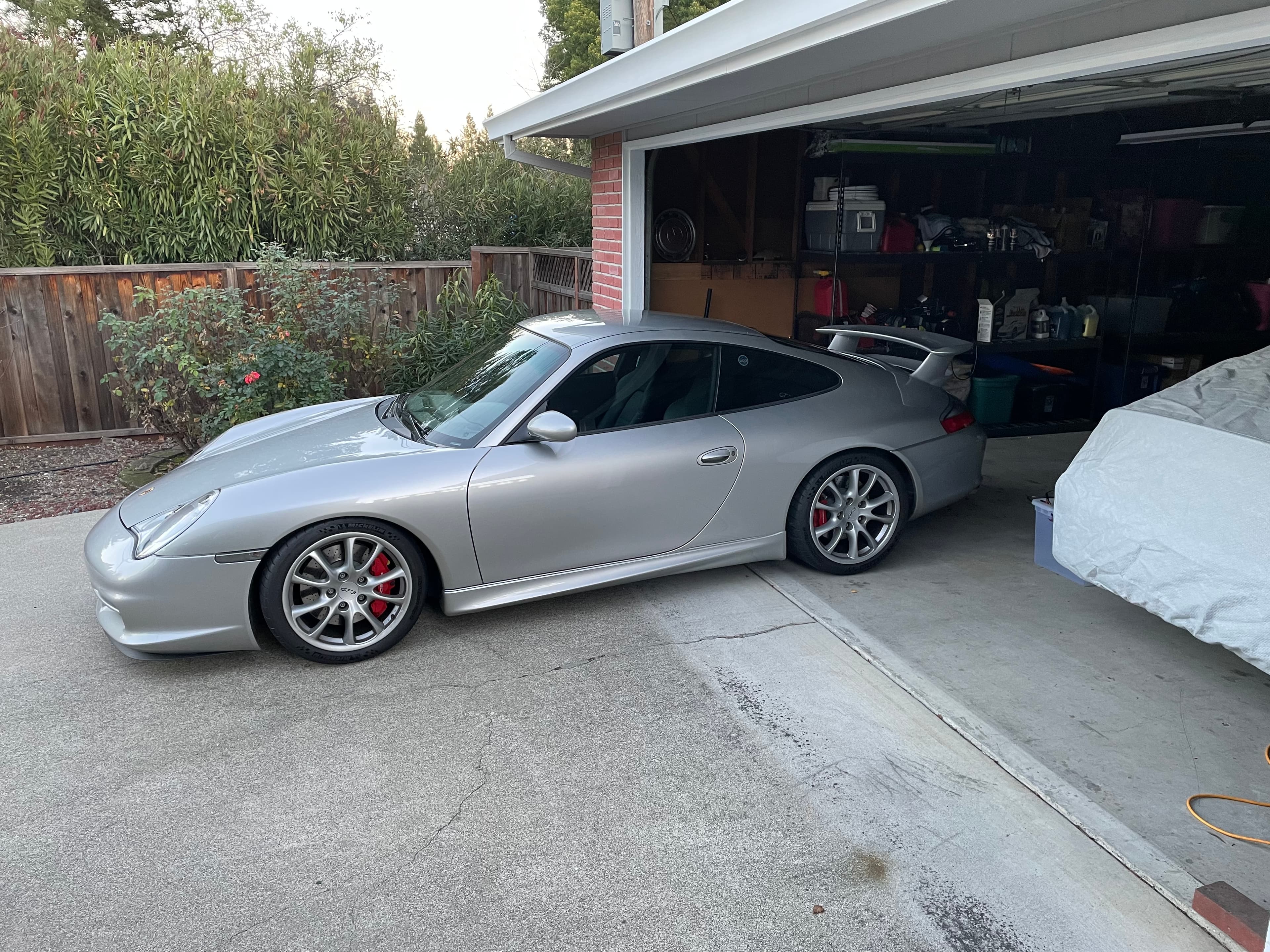 Matthew Herman’s silver 996.2 GT3 parked beside an open garage