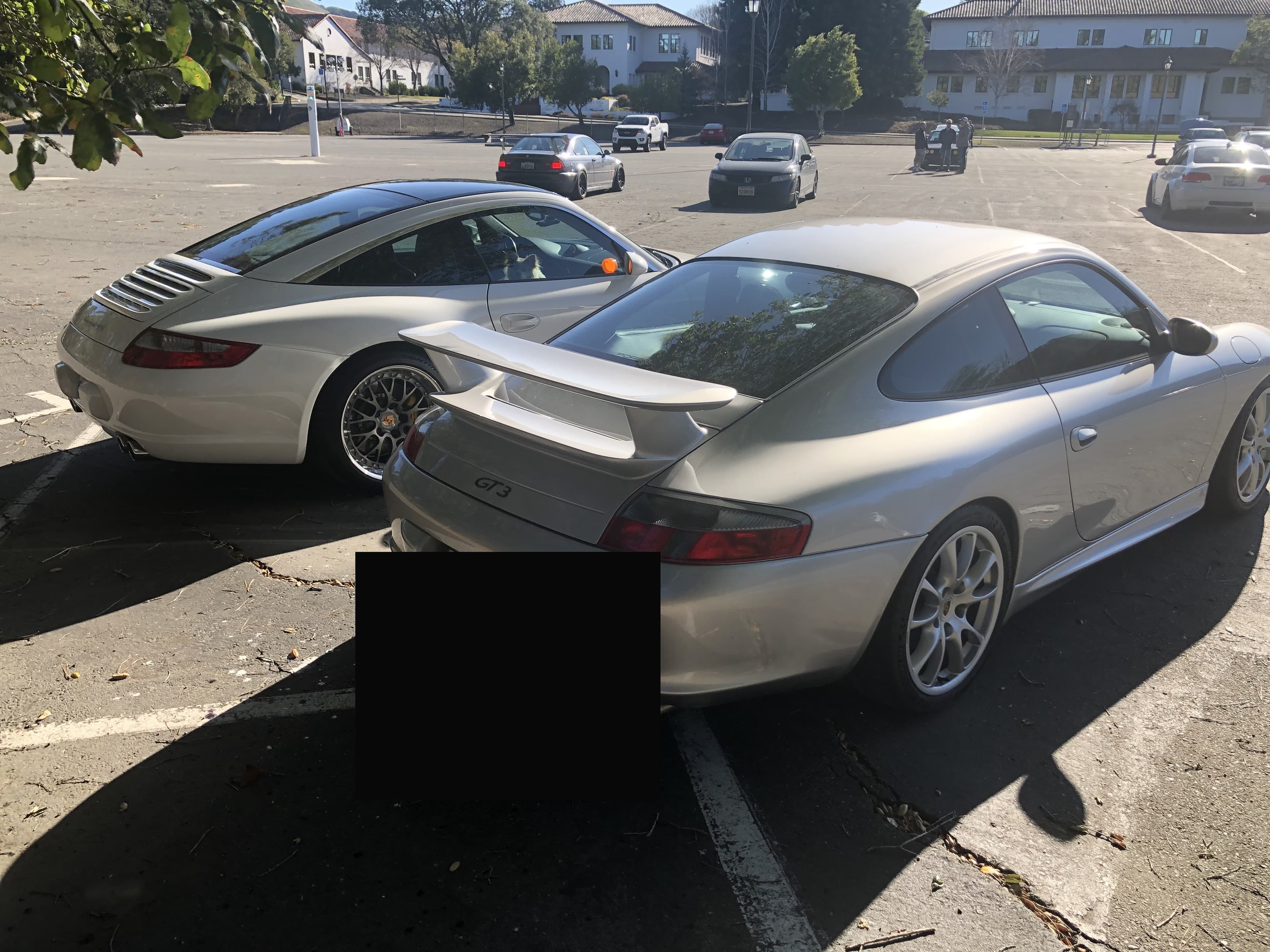 Rear three-quarter of Matthew Herman’s silver 996.2 GT3 at a parking-lot meet